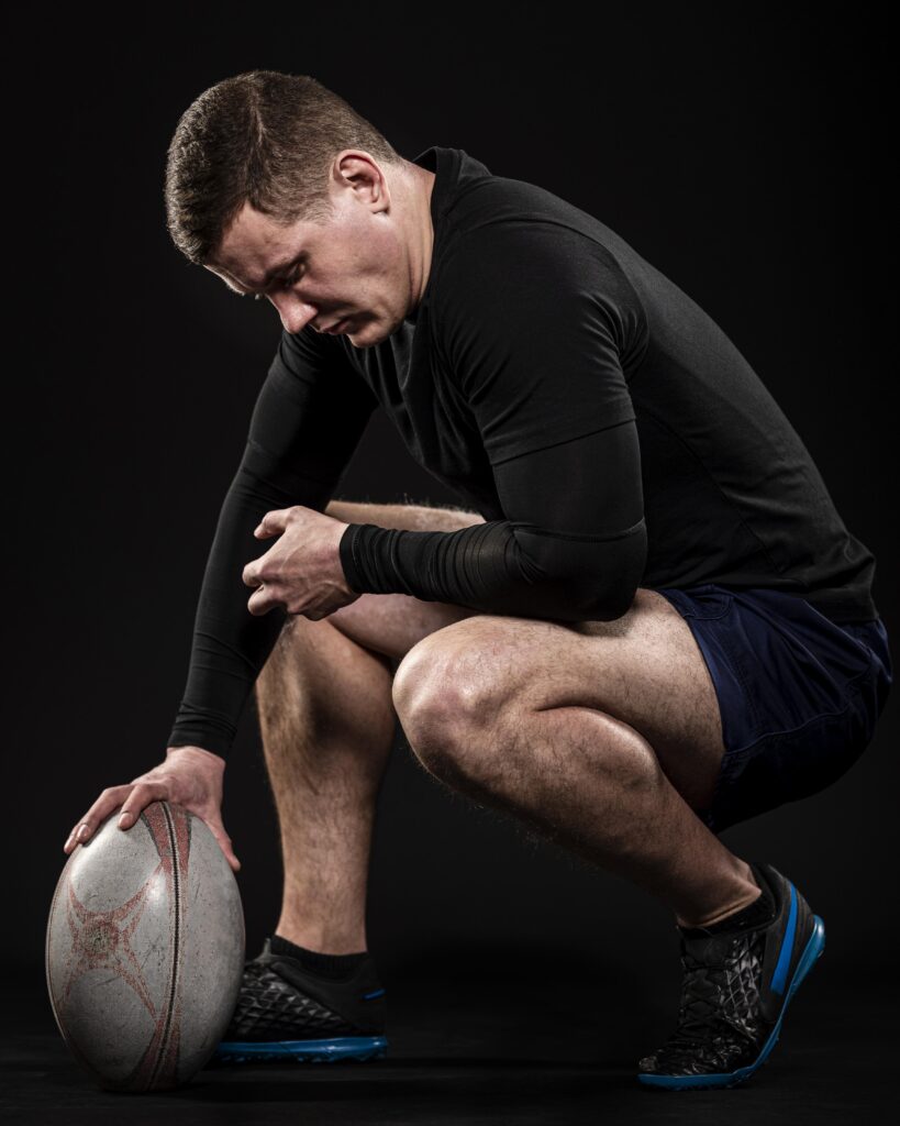 side-view-male-rugby-player-holding-ball-with-one-hand